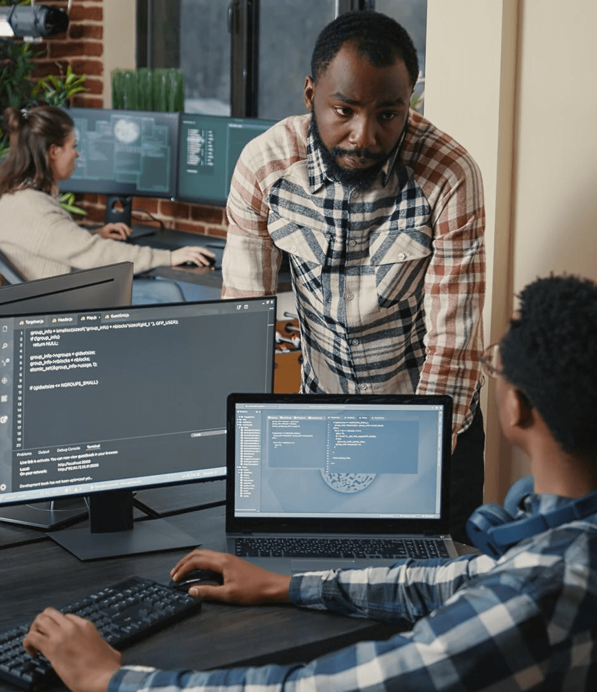Two people working on computers in an office
